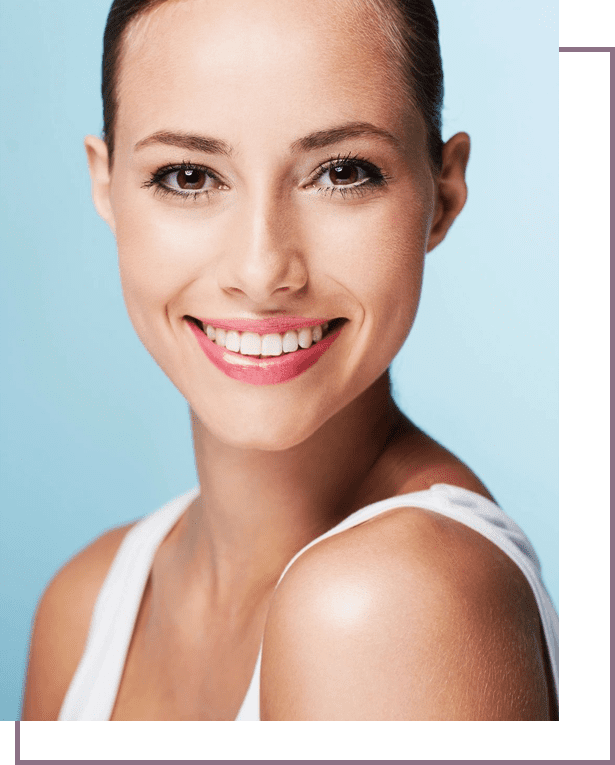 A woman with white teeth smiling for the camera.