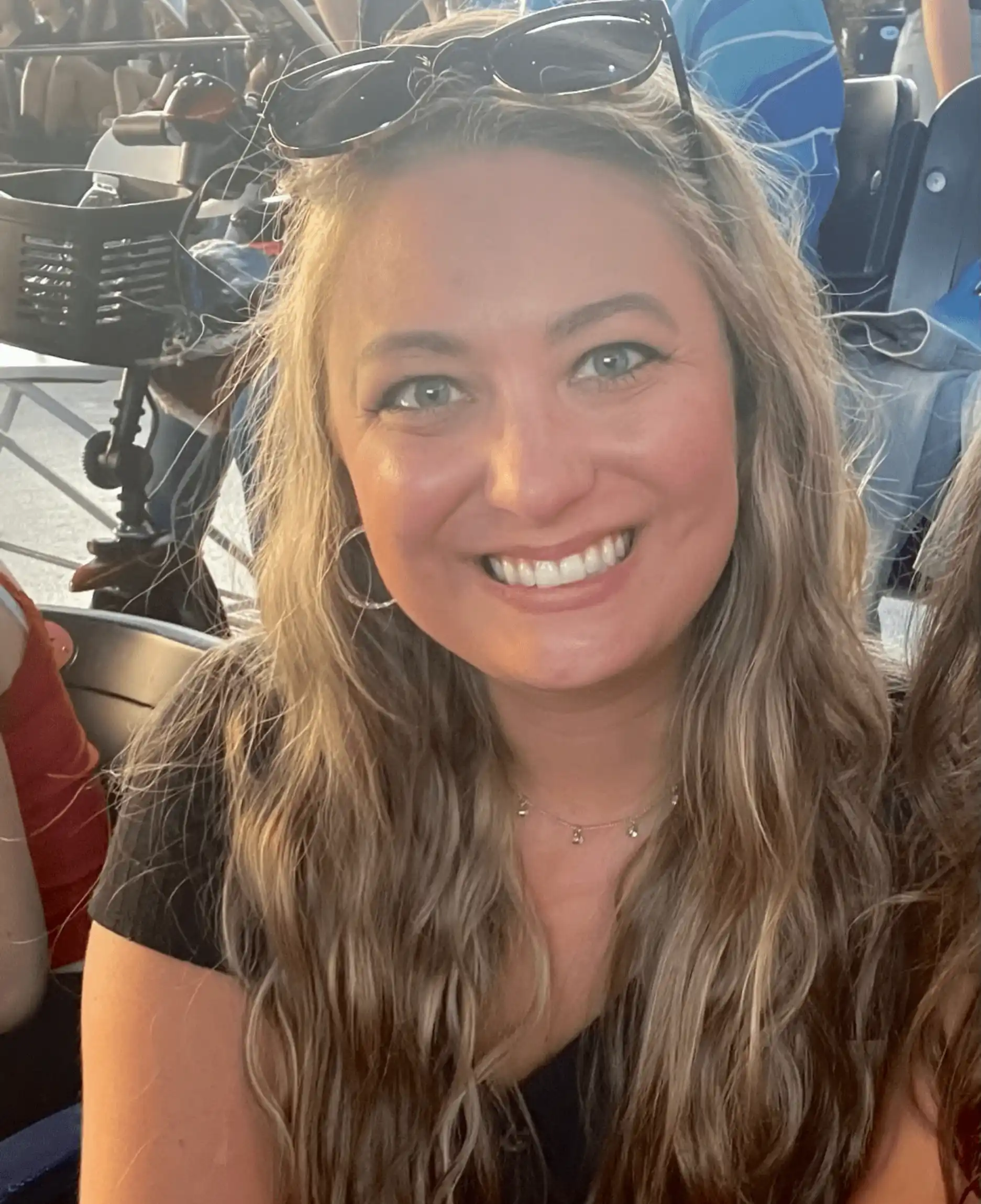 A woman with long hair smiles for the camera.